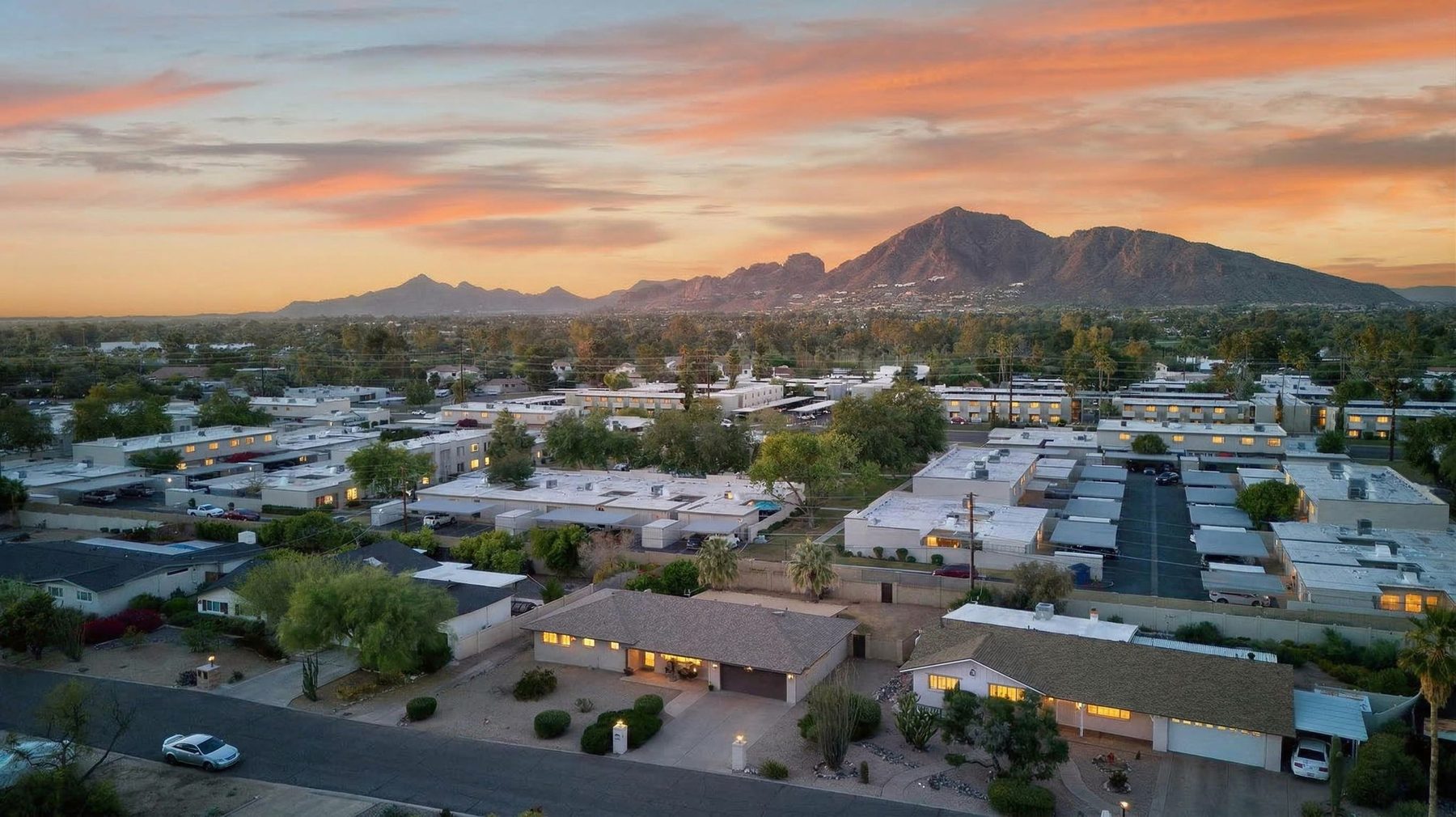 South Scottsdale rooftops at sunset with Camelback Mountain in the distance